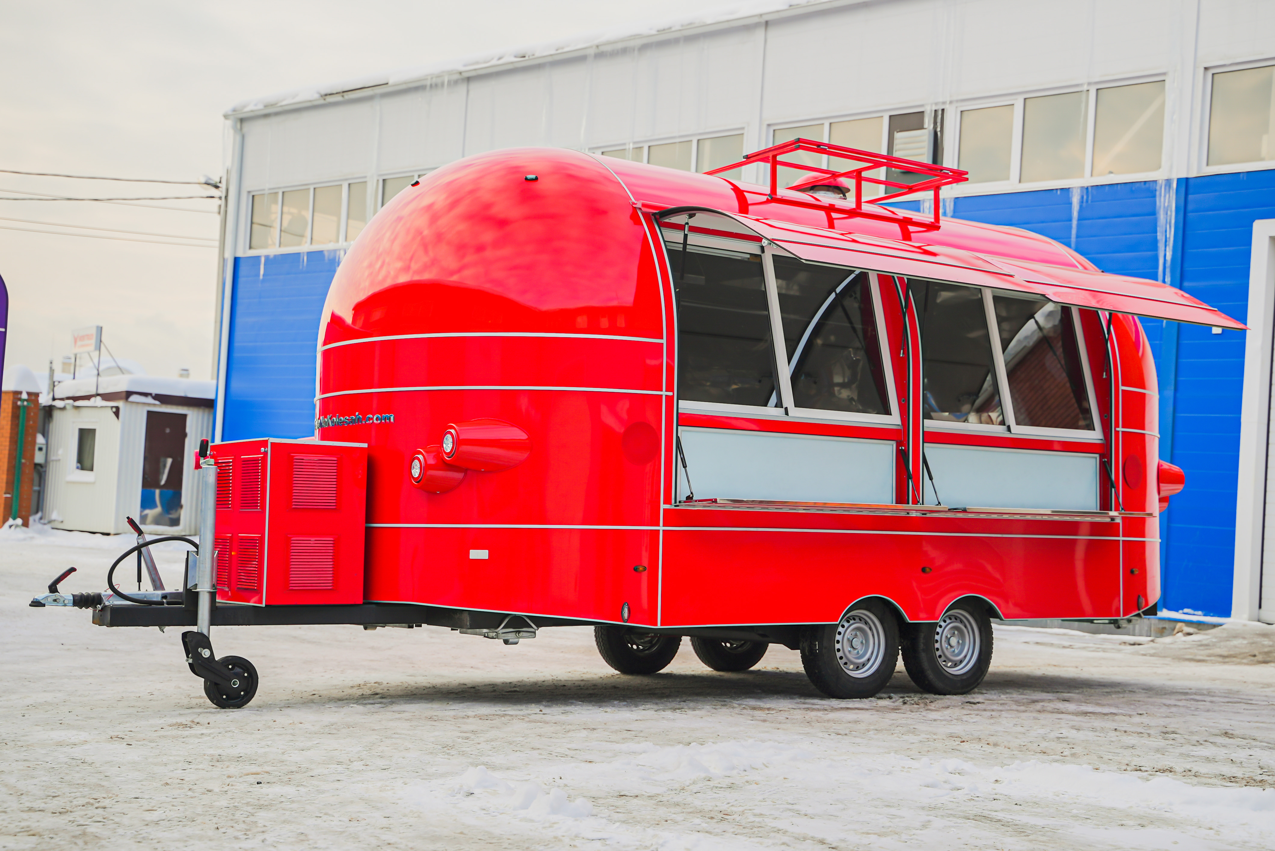 Red MobiAir commercial trailer with open service windows