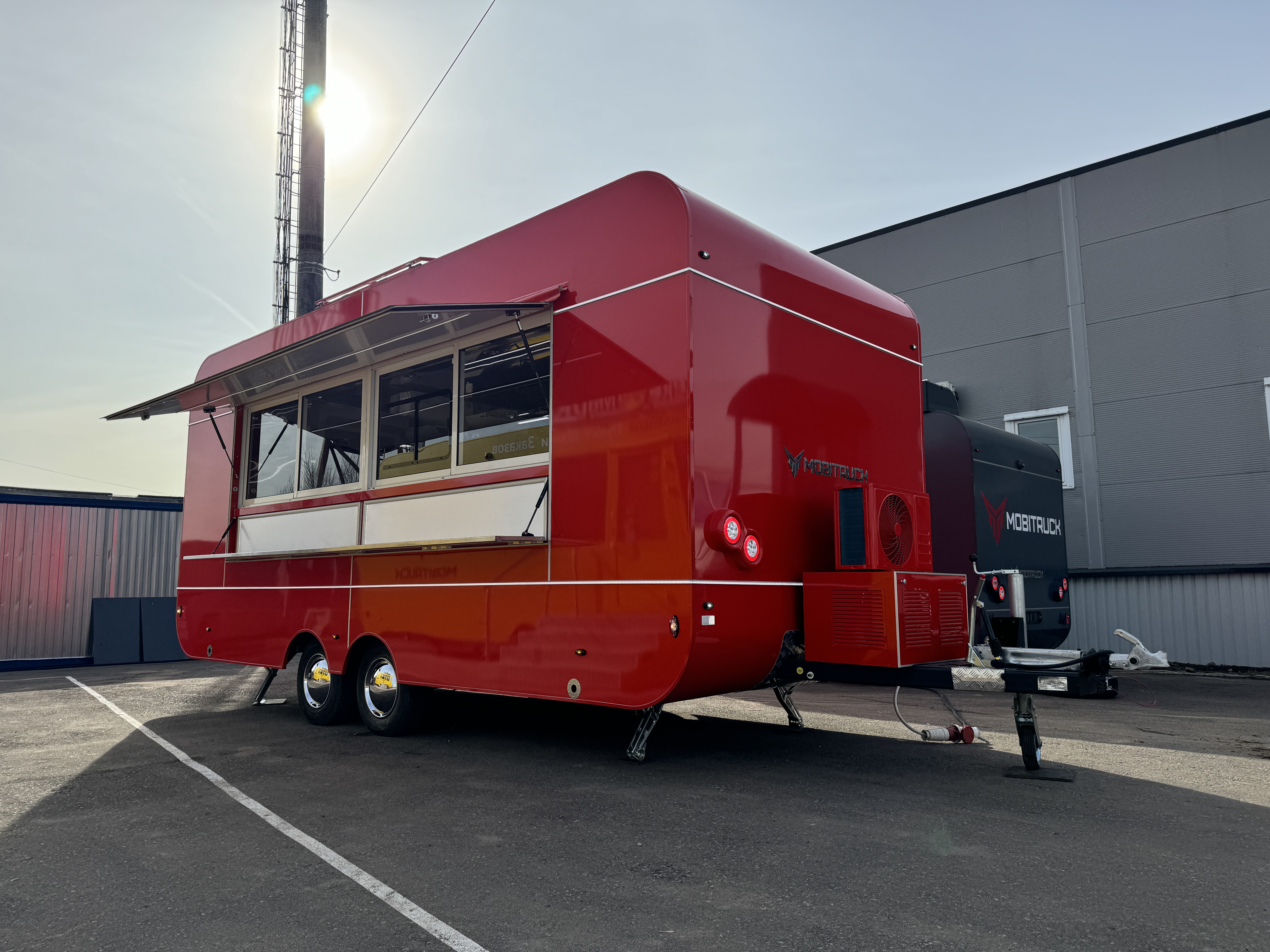 Red MobiCube commercial food trailer with a full service side