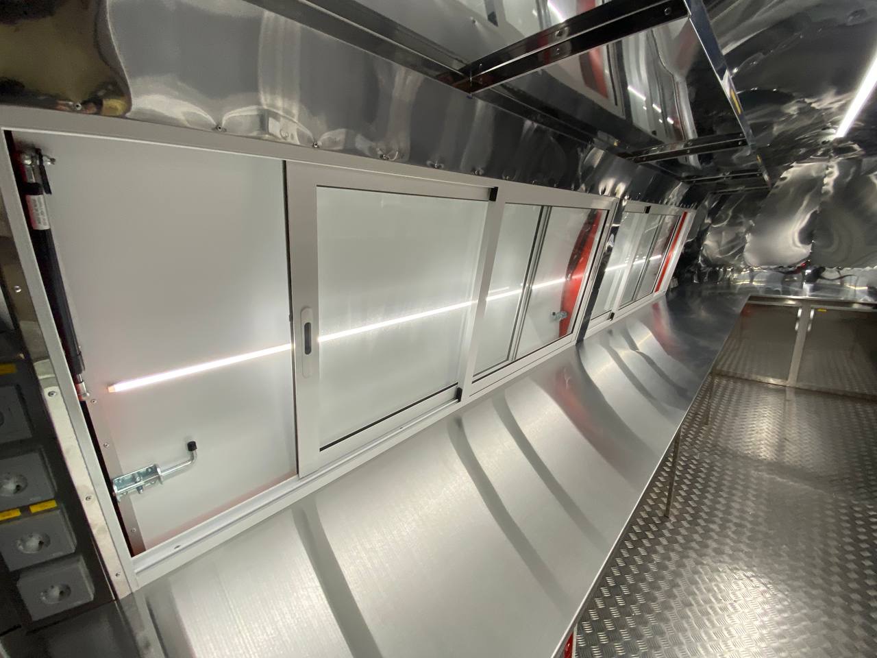 Integrated cabinets and storage inside the red MobiAir trailer