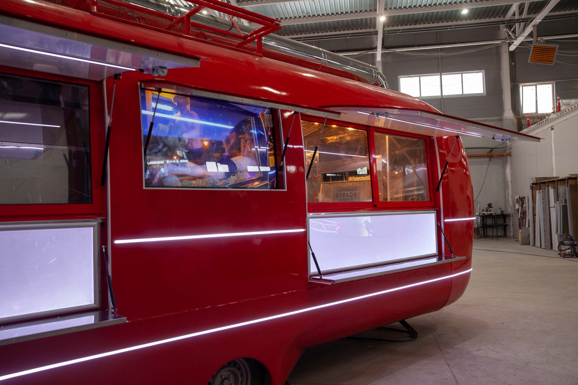 MOBITRUCK mobile service unit with a full-height customer service opening inside the production facility