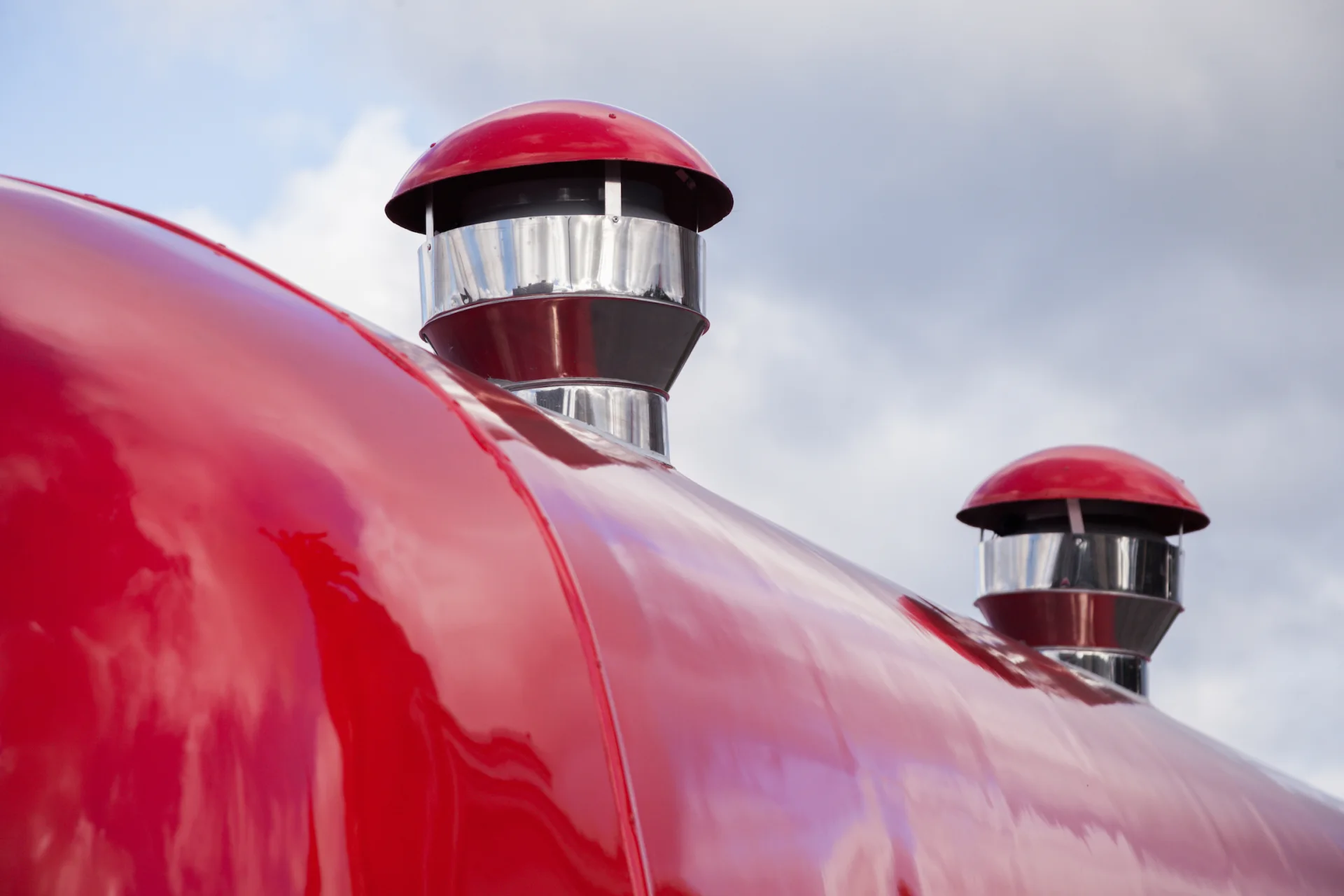 Two capped ventilation stacks on the curved red MobiEdge 8 roof