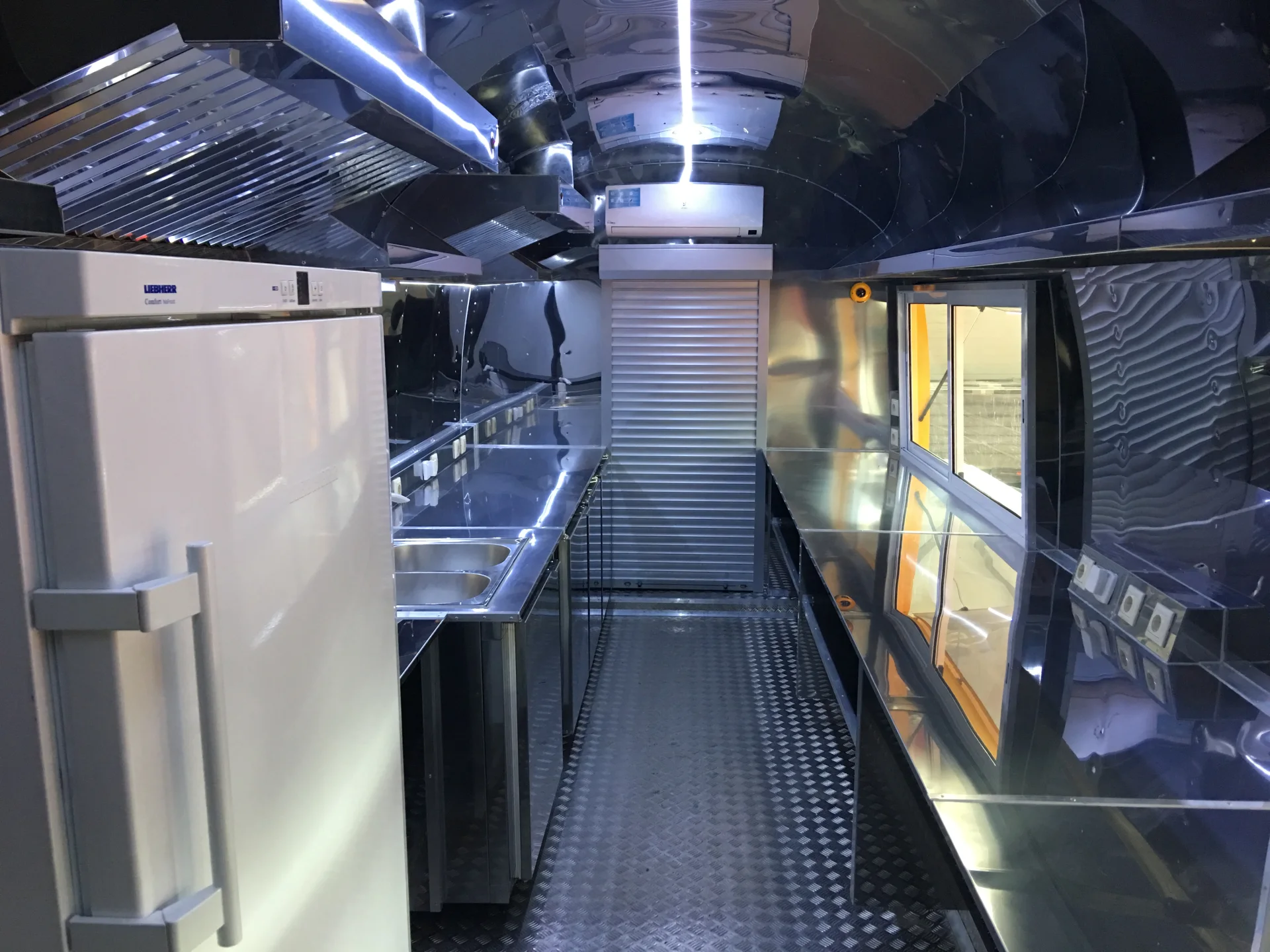 MobiEdge 8VT stainless-steel kitchen interior with refrigerator extraction hood sink and service opening