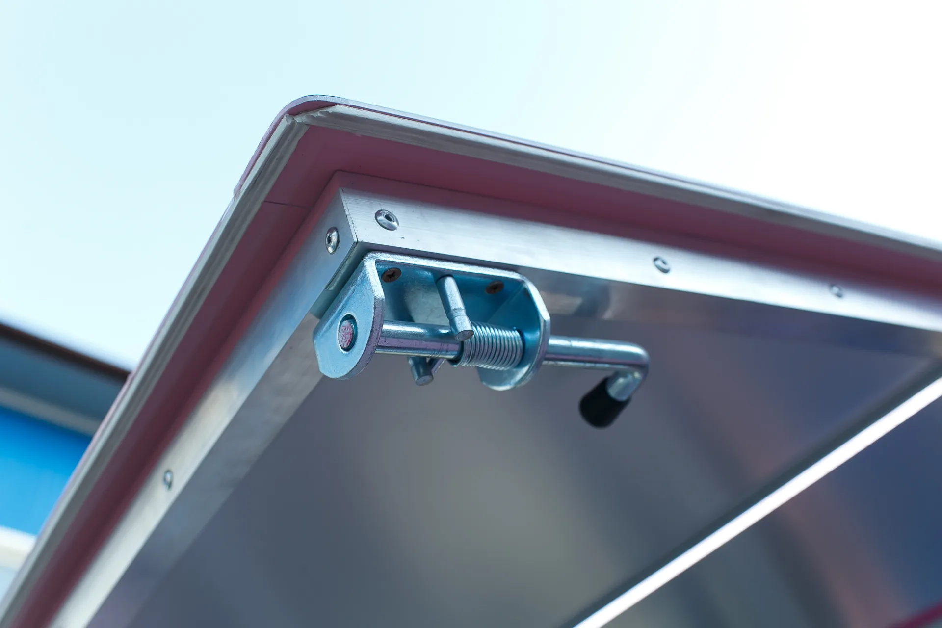 Close view of the metal latch and illuminated edge on a MobiEdge service hatch