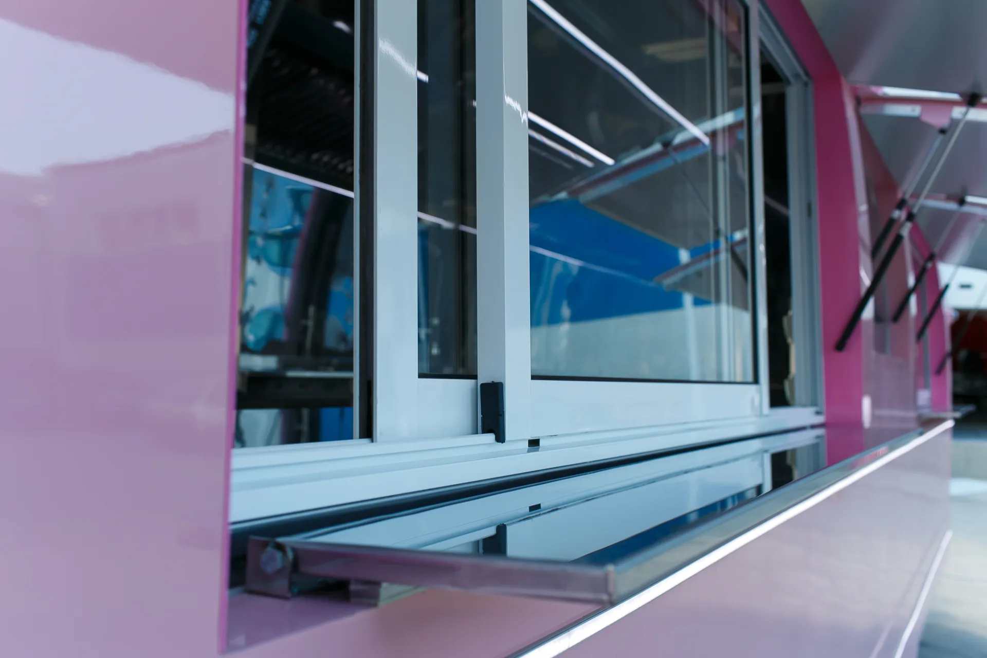 Sliding service window and stainless counter rail on a pink MobiEdge 8VT