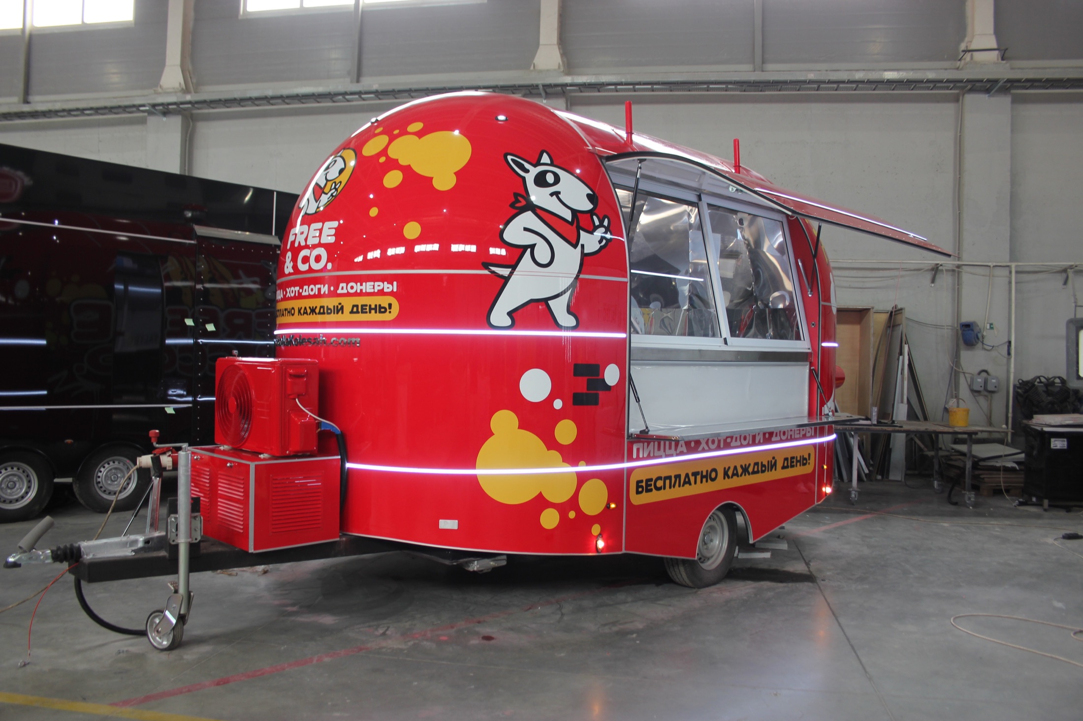 Free and Co. red mobile food trailer with the service window open