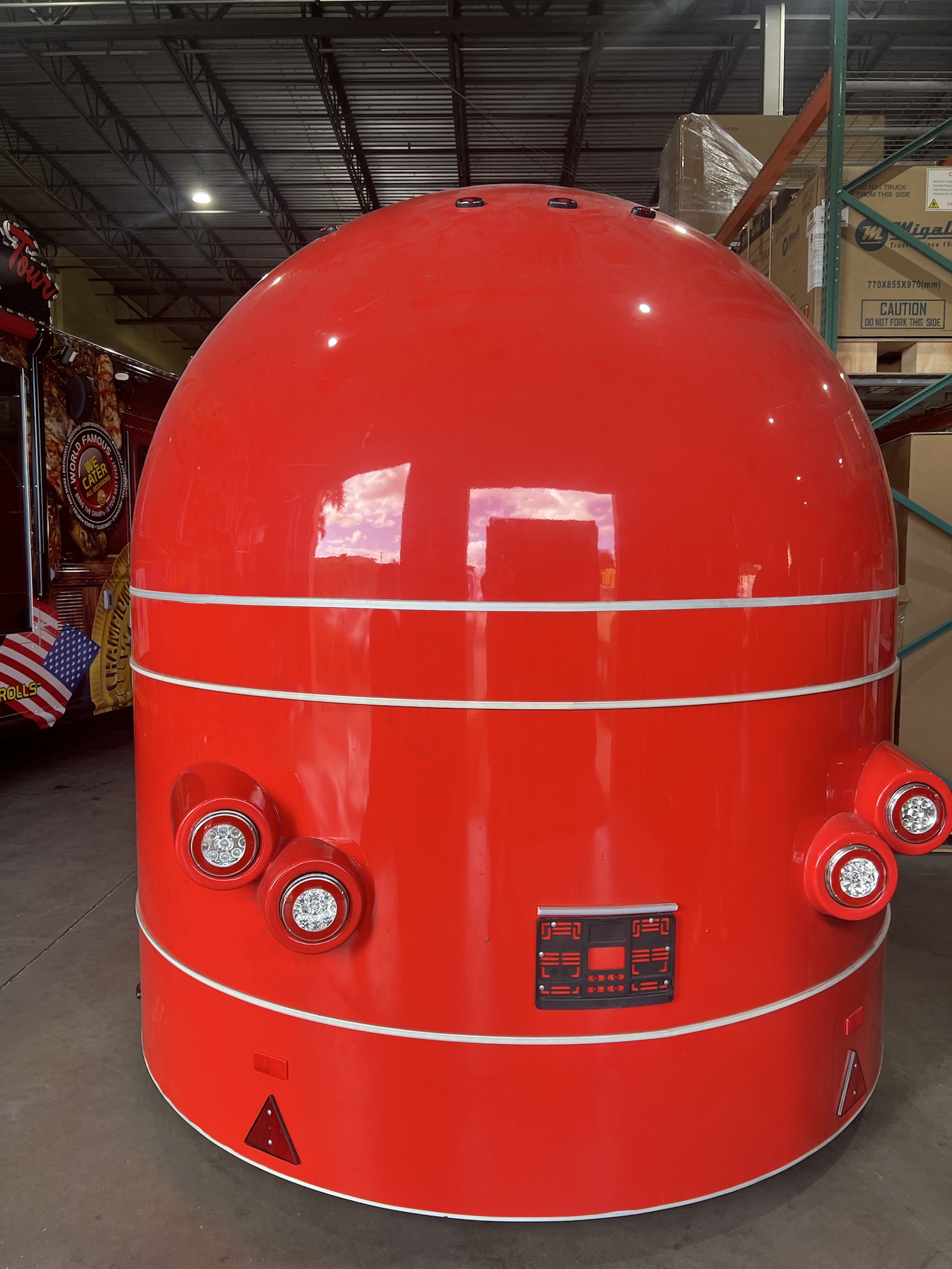 Straight front view of the red MobiAir commercial trailer