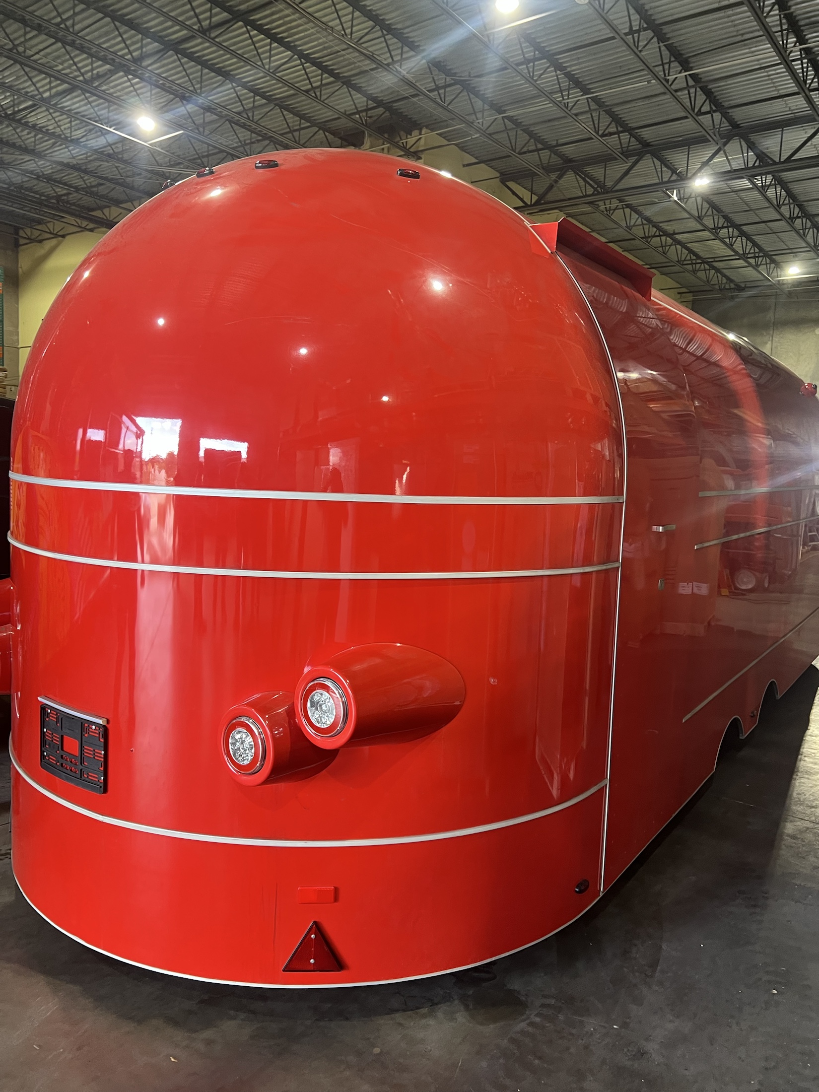 Red rounded MobiAir commercial trailer at the Deerfield Beach final-build location