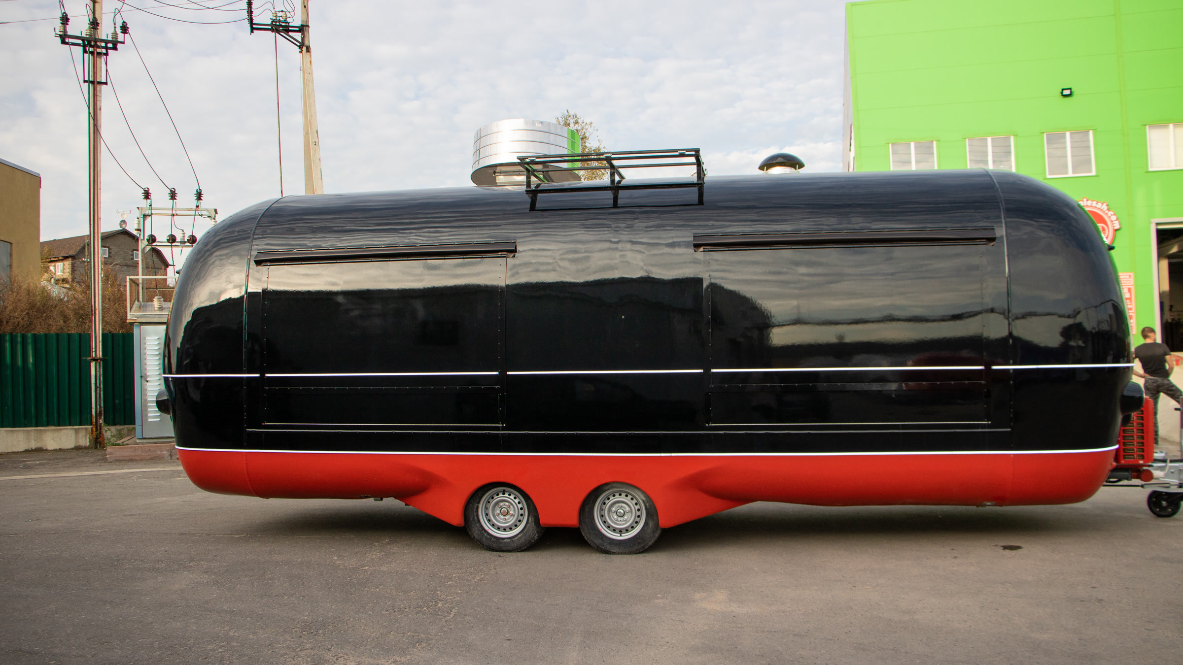 Long black and red MobiAir commercial trailer shown in full side profile with closed service panels