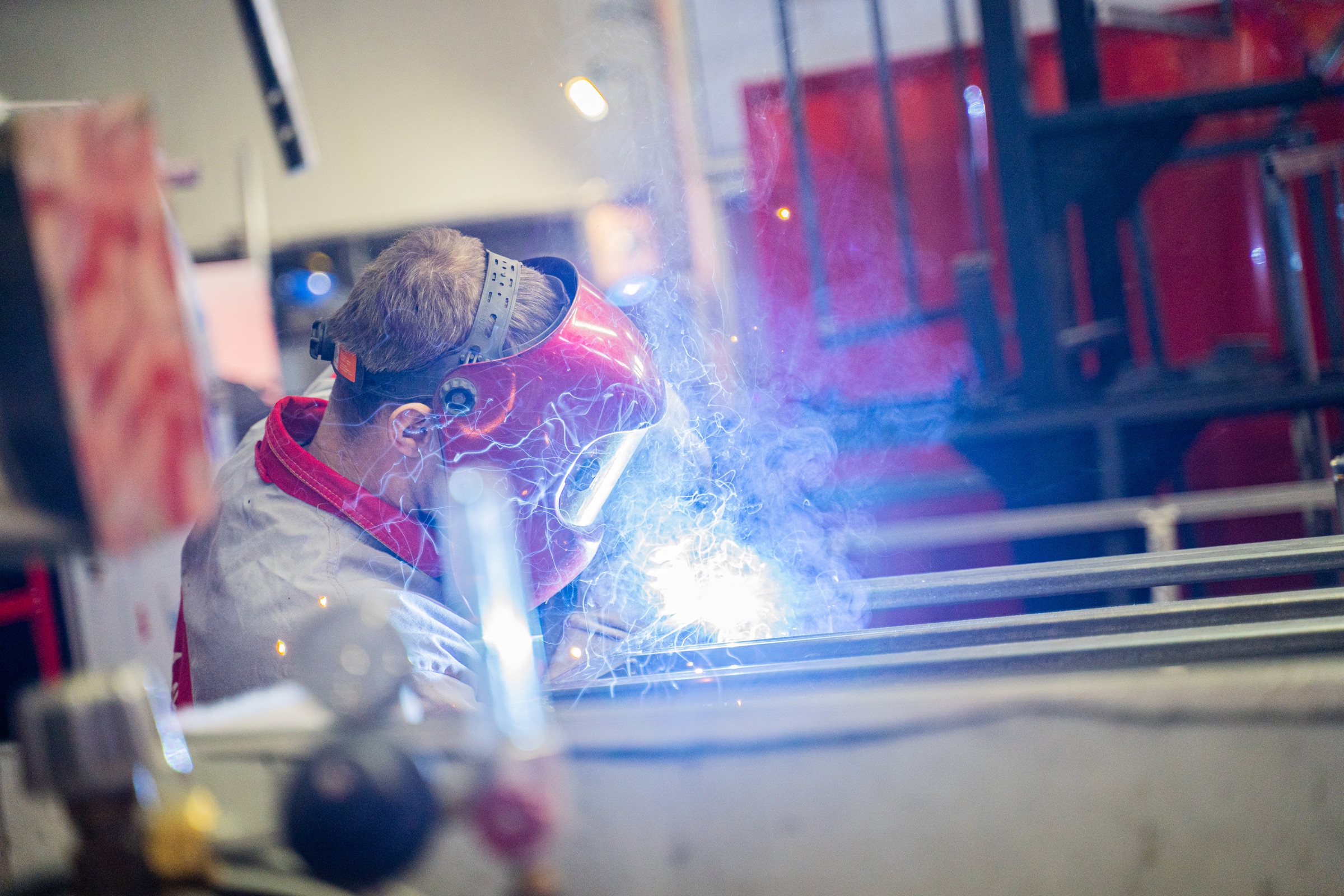 MOBITRUCK fabricator welding a commercial trailer frame during shell production