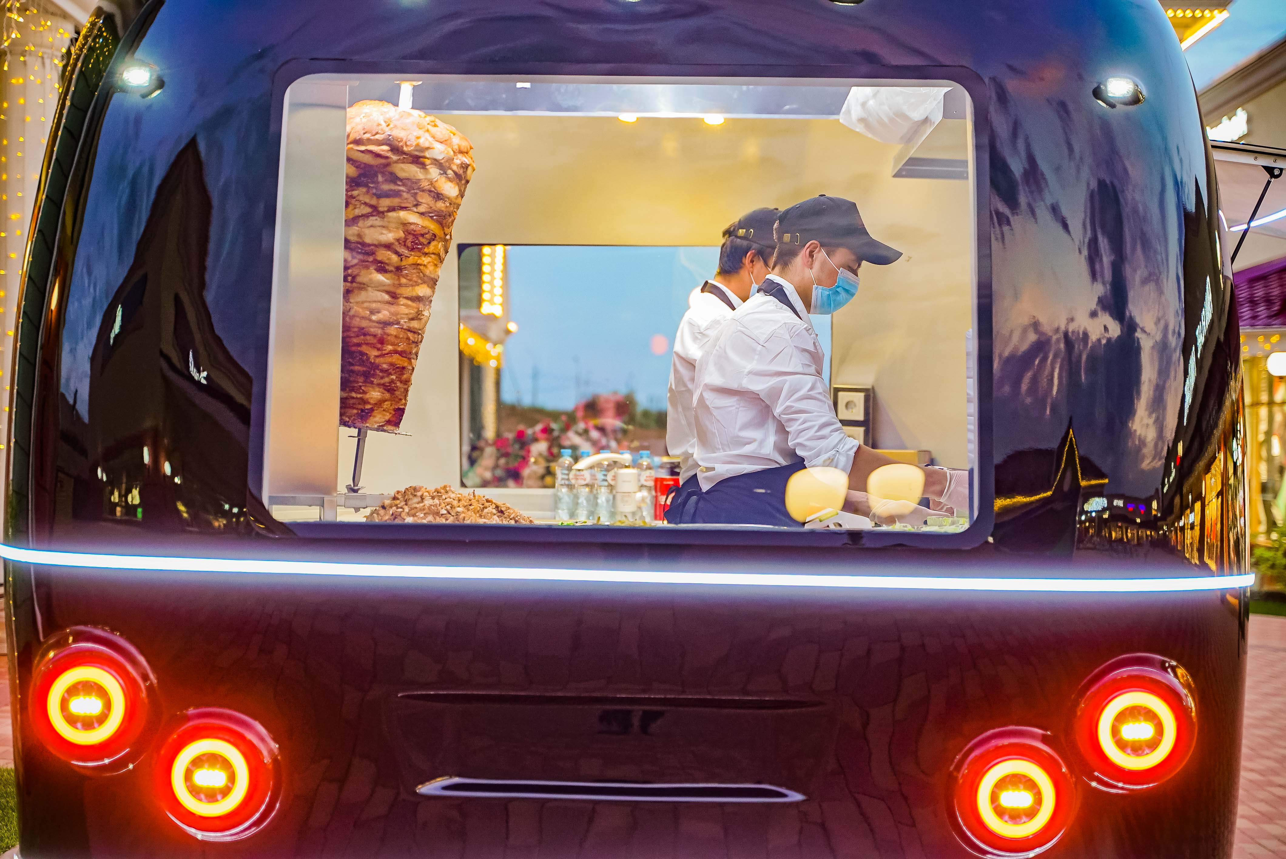 Operating MOBITRUCK food trailer with staff working at the service window