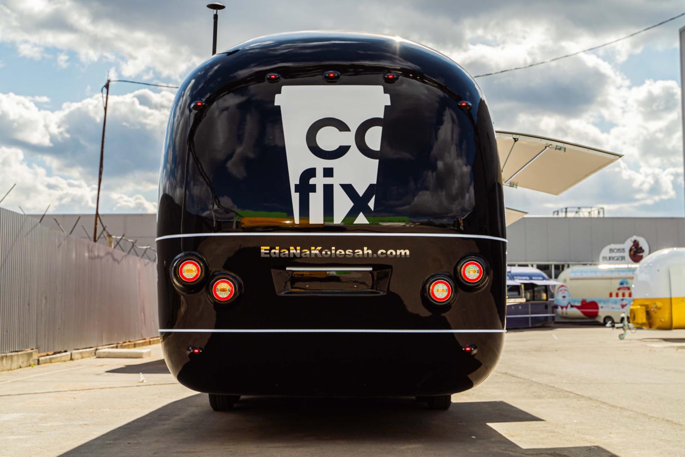 Black Cofix-branded MOBITRUCK coffee shop trailer viewed from the rear
