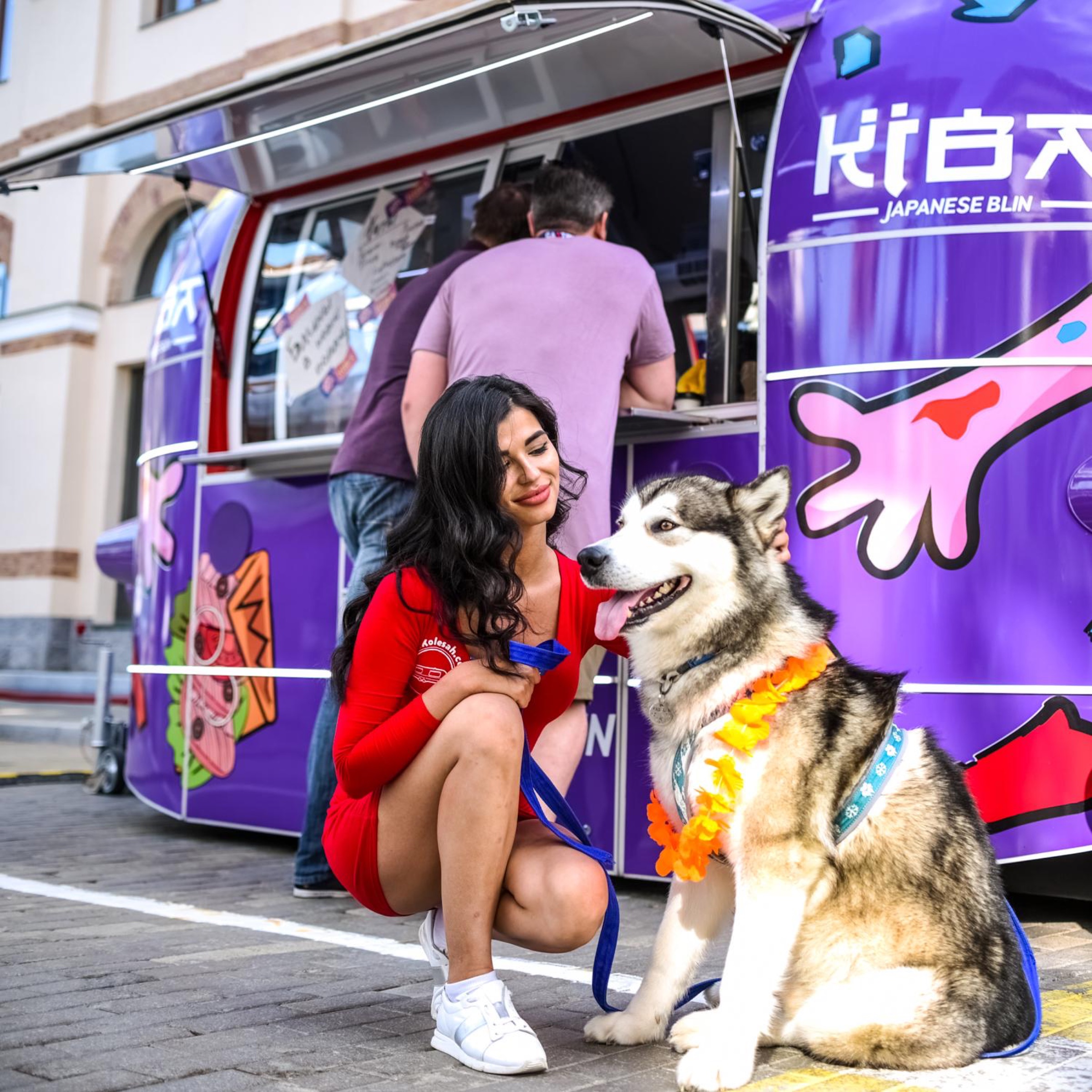 Guest and husky beside the KIBA food trailer service window