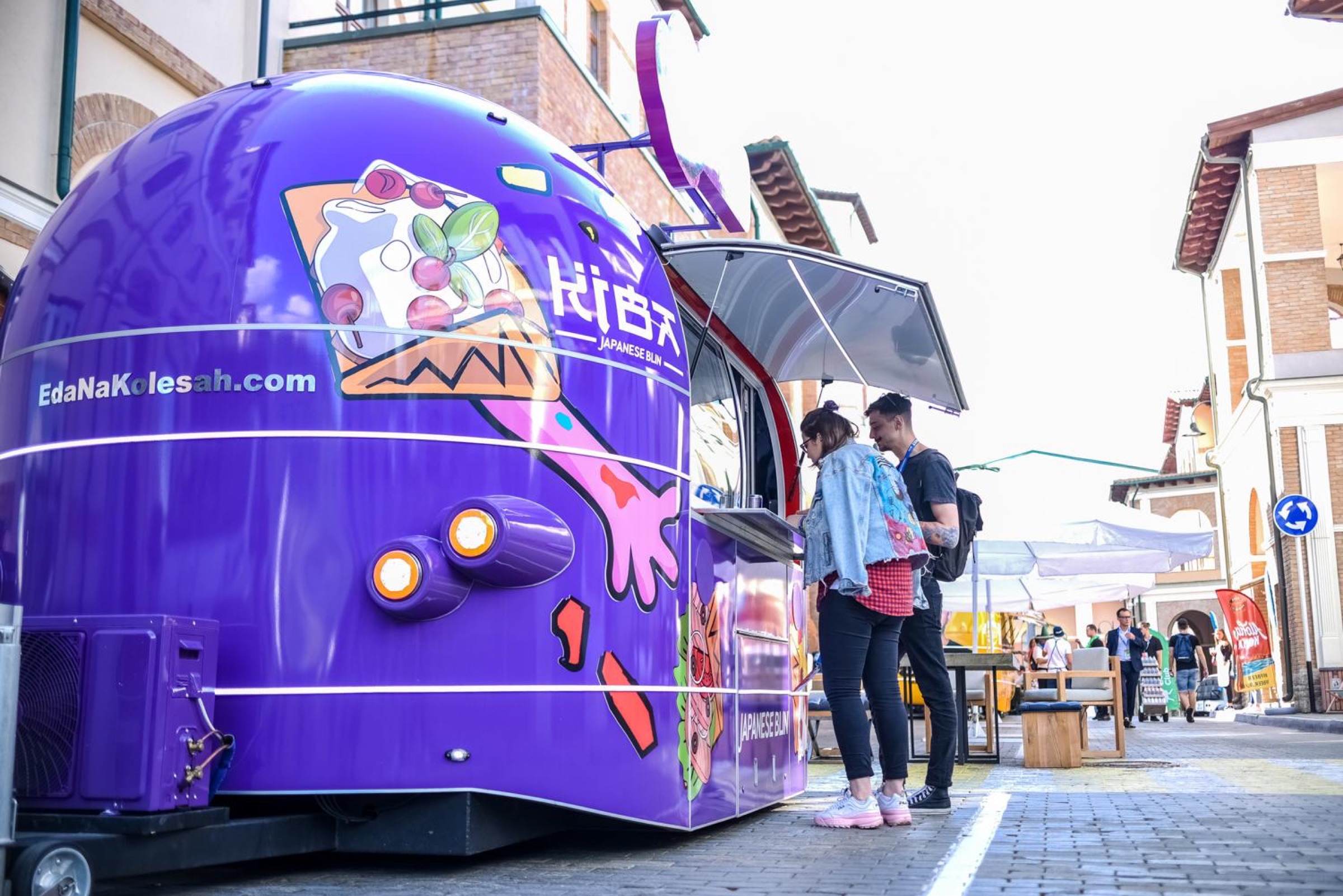 Purple KIBA Japanese Blin food trailer serving customers at a live event
