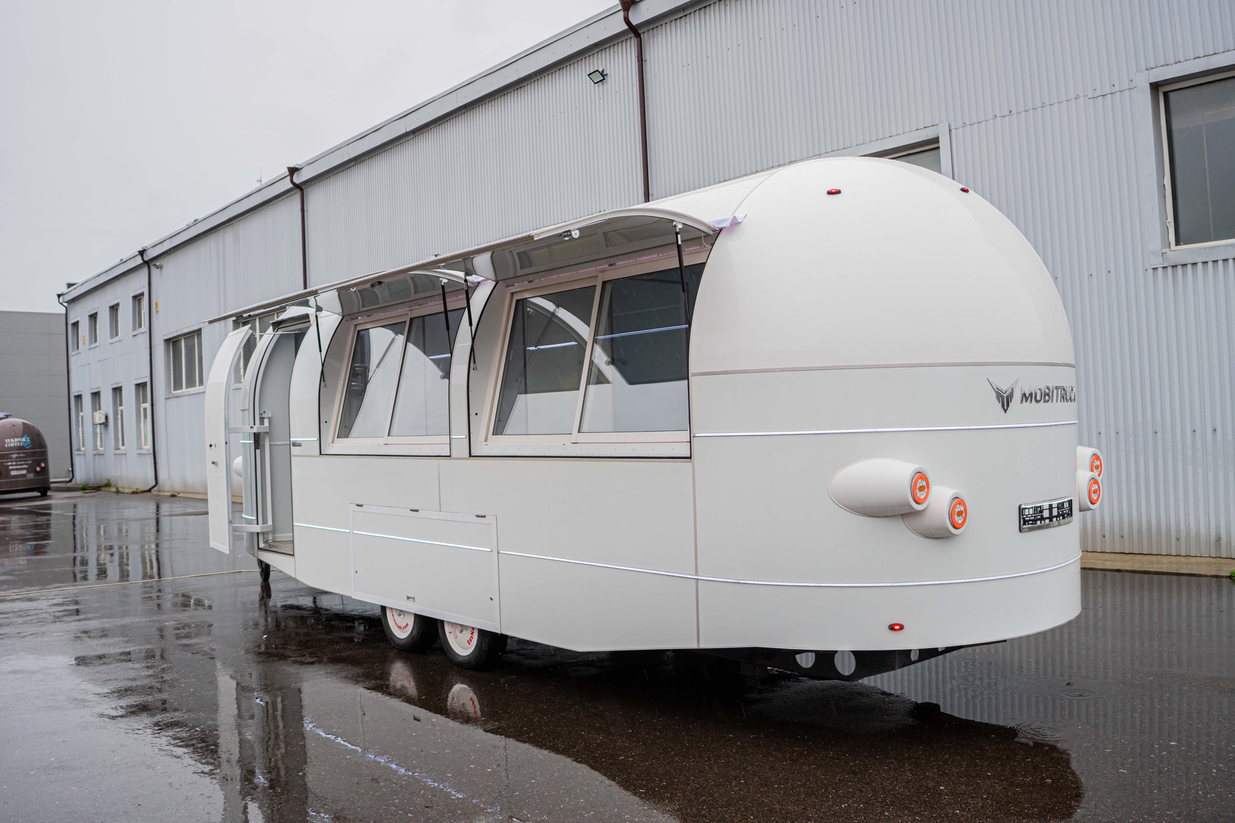 MobiCryo trailer with its large side windows and awnings open
