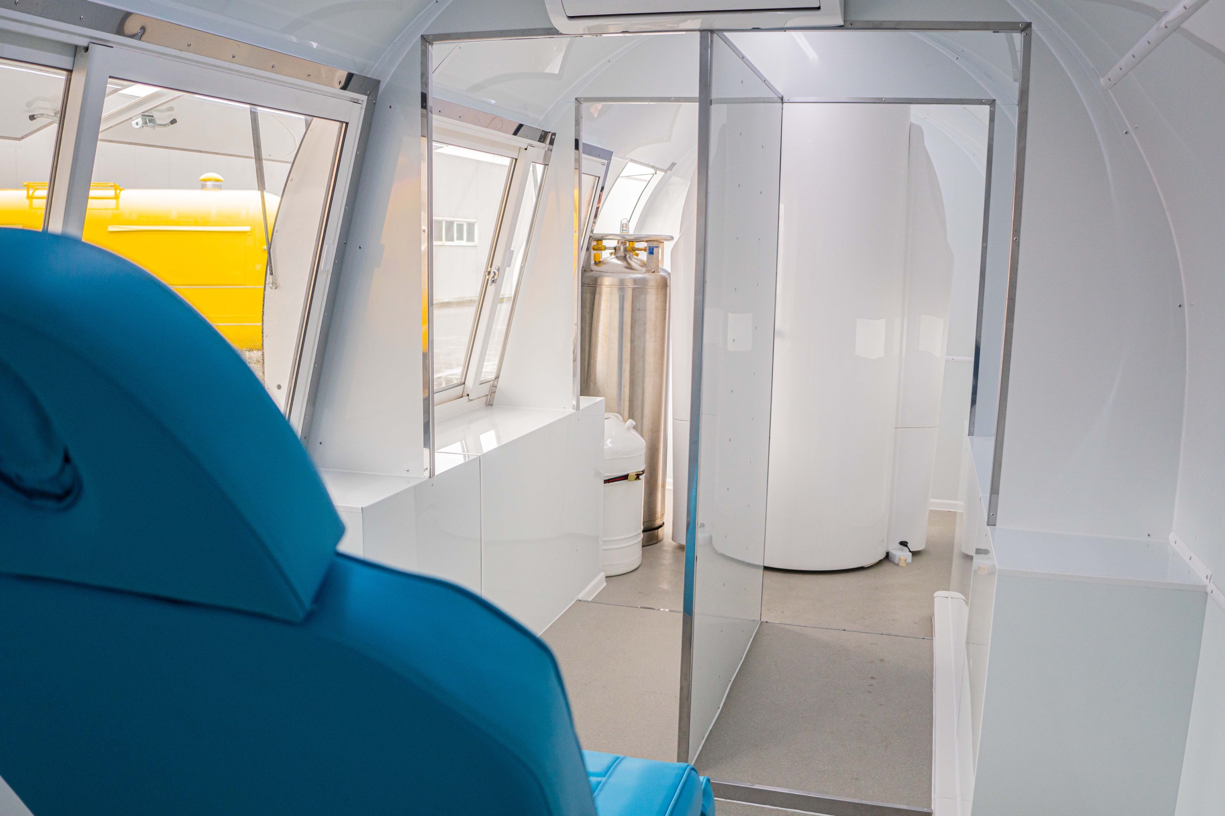 MobiCryo interior with seating, storage and cryotherapy chamber