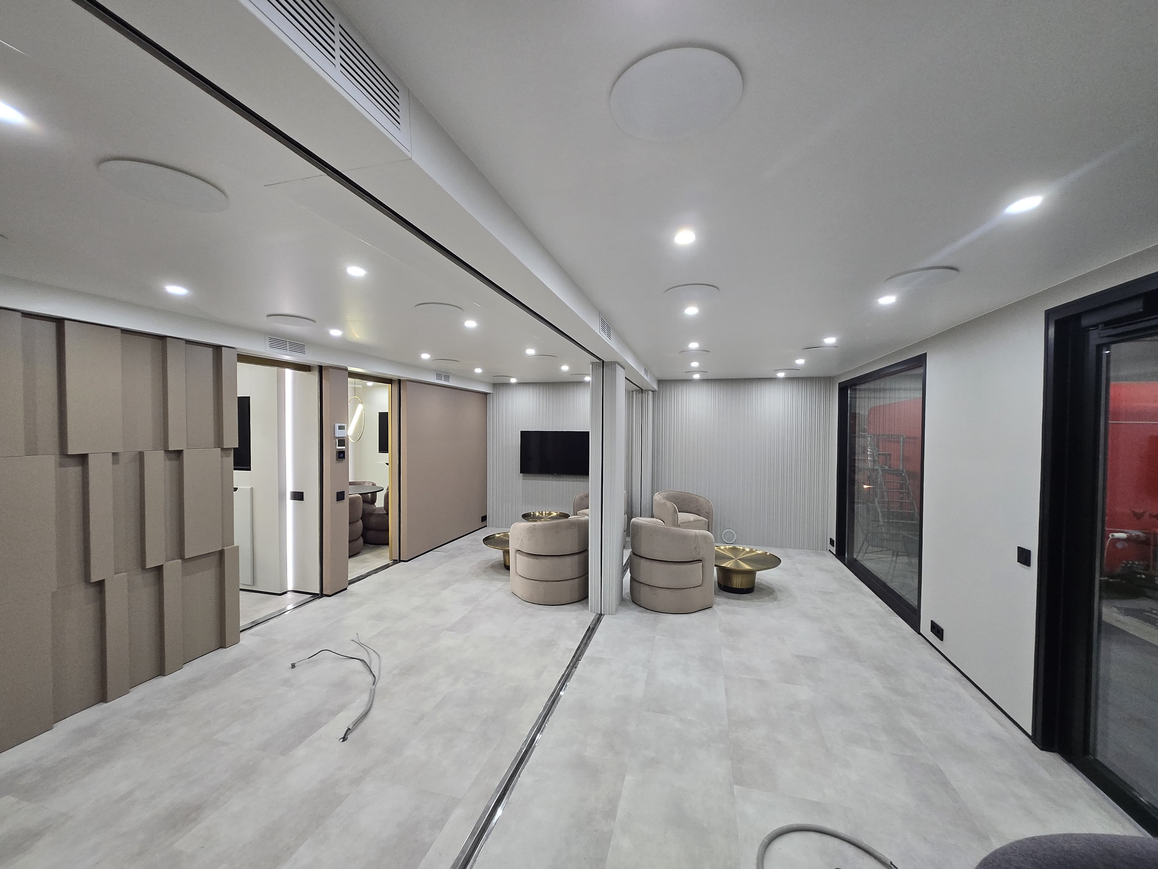 Finished mobile office interior with meeting seats, acoustic wall treatment and integrated lighting
