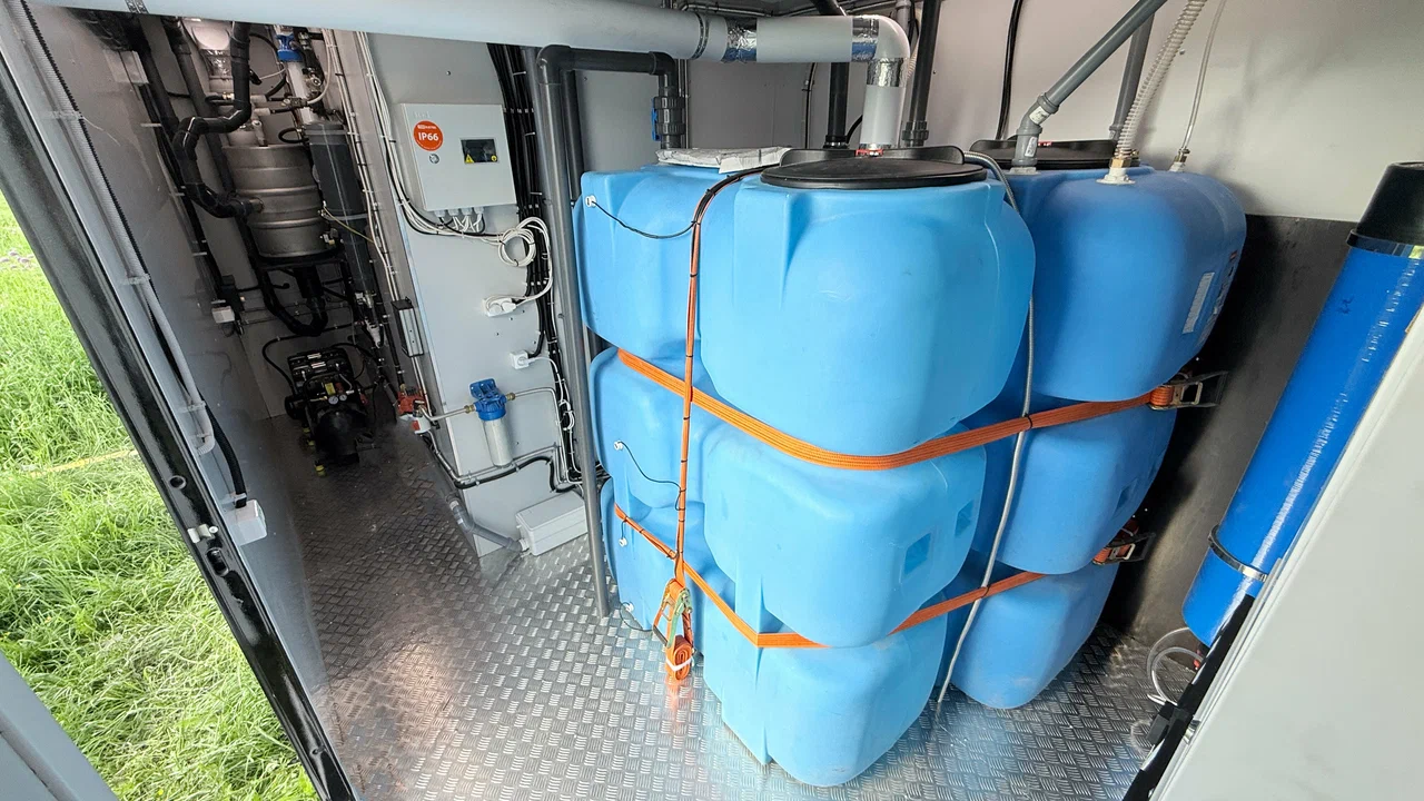 Mobile restroom technical compartment with water tanks, piping, pumps and controls