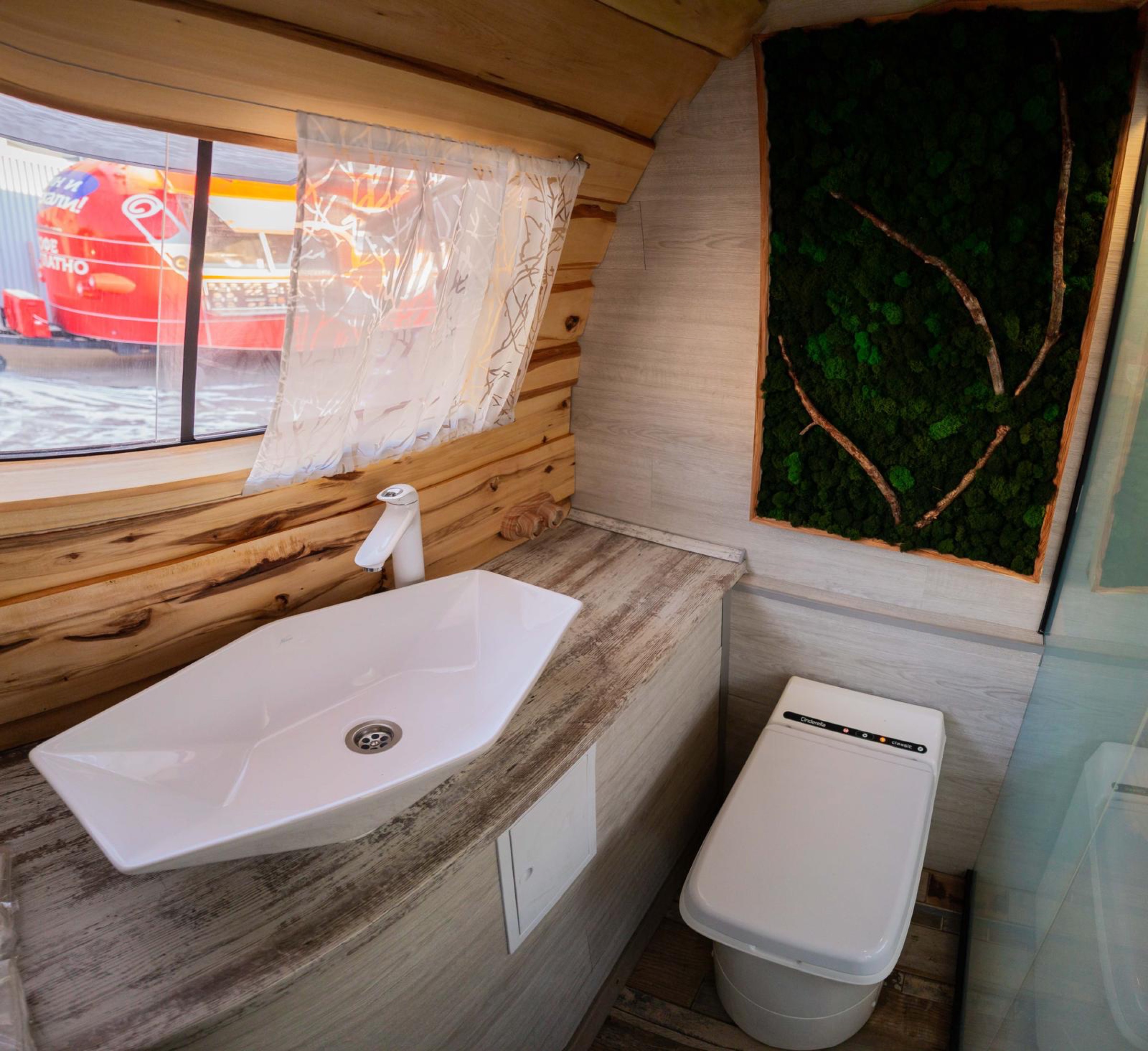 MobiSauna washroom with sink, toilet and natural wood finishes