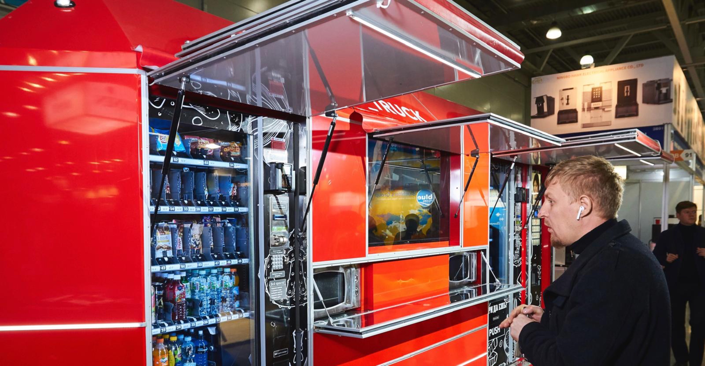 Customer viewing the open service side of the red MobiVending unit
